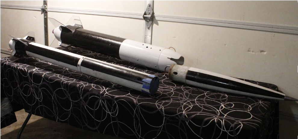 Booster, sustainer, and nose cone on a table.