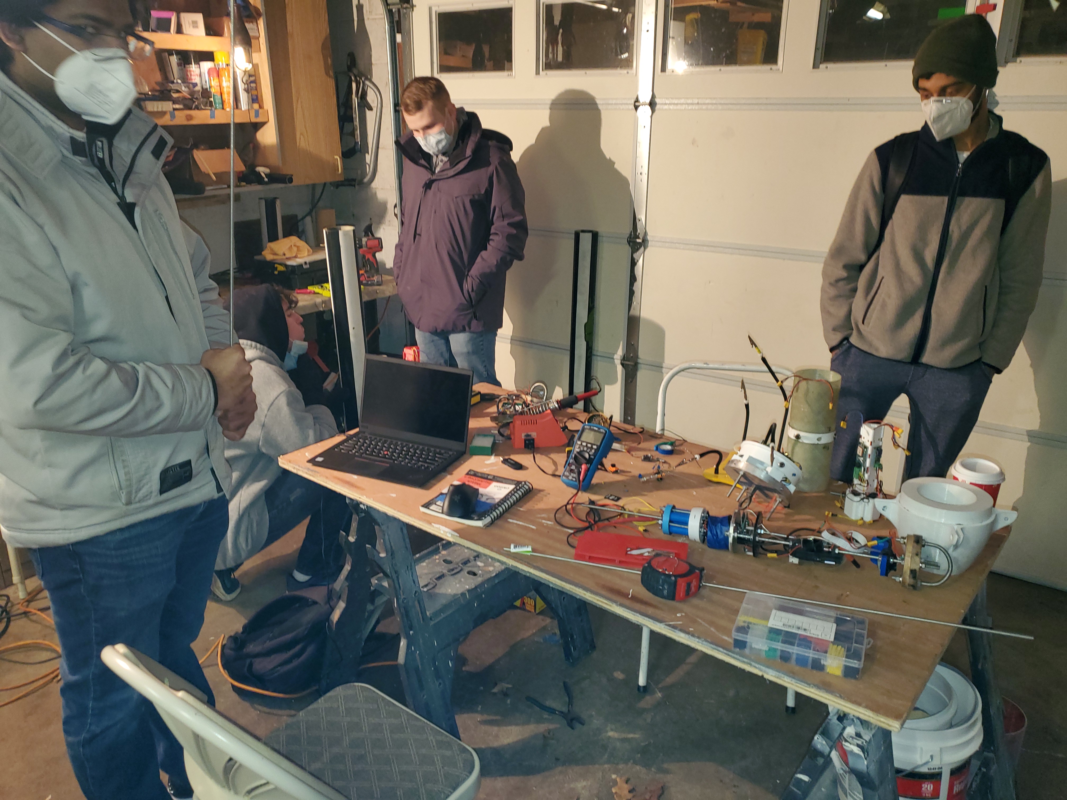 Aerobody team conducting assembly in garage.